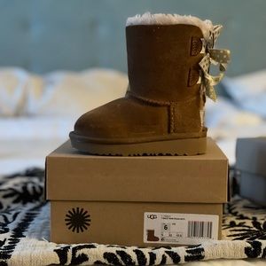Lightly used toddler UGG boots with bows.